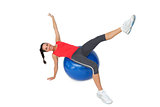 Fit young woman stretching on exercise ball