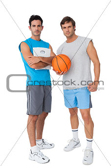 Two fit young men with scales and basketball