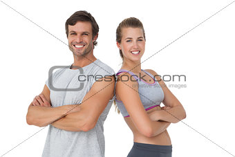 Portrait of a sporty young couple with arms crossed