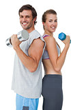Portrait of a fit couple exercising with dumbbell