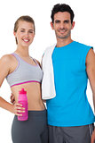Portrait of a sporty couple with water bottle and towel