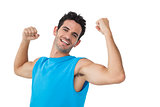Portrait of a smiling young man flexing muscles