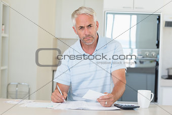 Serious man working out his finances