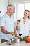 Laughing couple making dinner together