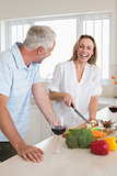Laughing couple making dinner together