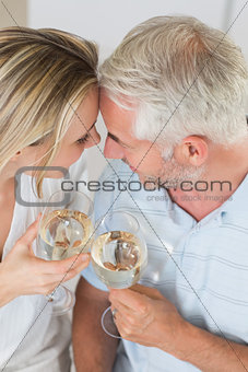 Happy couple having glass of wine together