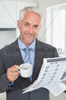 Smiling businessman having coffee in the morning before work