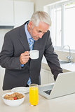 Focused businessman using laptop in the morning before work