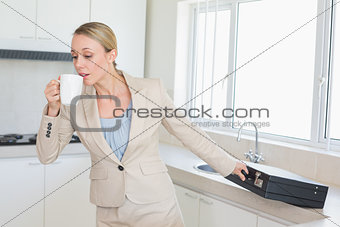Businesswoman rushing out the door to work in the morning