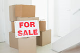 For sale sign with many cardboard boxes