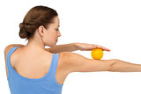 Rear view of a young woman holding stress ball on arm
