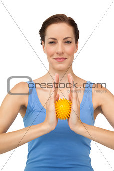 Portrait of a content young woman holding stress ball