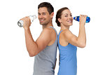 Happy fit young couple with water bottles