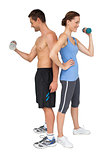 Fit young couple exercising with dumbbells