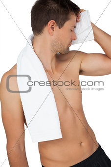 Shirtless tired man with towel