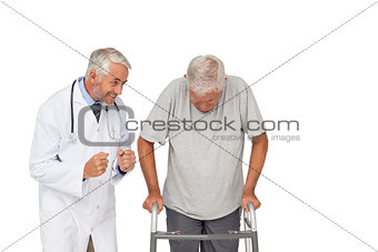 Doctor with senior man using walker