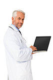 Portrait of a content male doctor using laptop