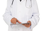 Mid section of a male doctor using digital tablet