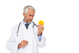Concentrated male doctor looking at stress ball