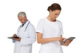Male and female doctors using digital tablets