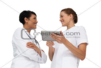 Two female doctors using digital tablet