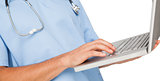 Close-up mid section of a male surgeon using laptop
