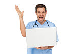 Portrait of a male surgeon with laptop shouting