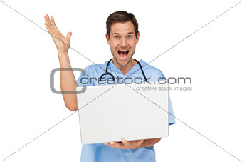 Portrait of a male surgeon with laptop shouting
