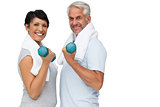 Fit mature couple exercising with dumbbells