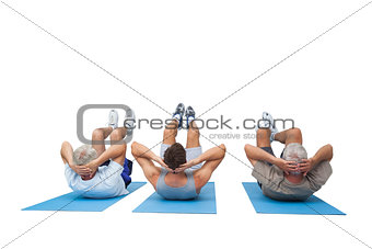 Full length of three men doing abdominal crunches