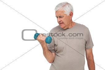 Portrait of a senior man exercising with dumbbell