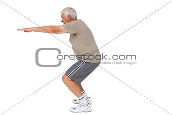 Full length side view of a senior man stretching hands