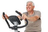 Portrait of a happy senior man on stationary bike