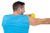 Rear view of a content young man holding stress ball