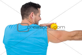 Rear view of a content young man holding stress ball