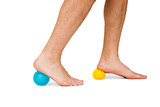Close-up low section of man standing over stress balls