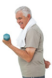 Side view of a senior man exercising with dumbbell