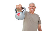Portrait of a senior man exercising with kettle bell