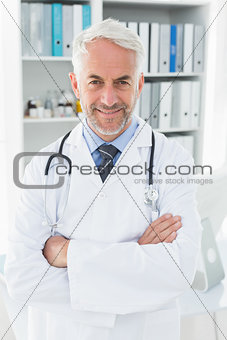 Portrait of a smiling confident male doctor at medical office