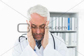 Close-up of a male doctor with severe headache
