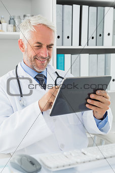 Doctor using digital tablet at medical office