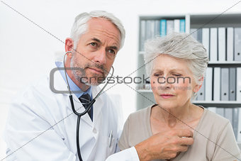 Doctor checking patients heartbeat using stethoscope