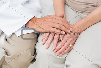 Mid section of a senior patient visiting doctor