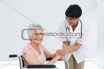 Doctor talking to a senior patient in wheelchair