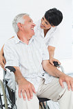 Portrait of a nurse with senior patient sitting in wheelchair