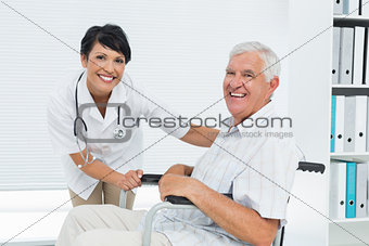 Female doctor with senior patient in wheelchair