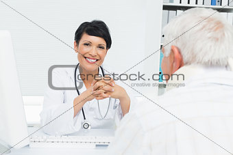 Portrait of a smiling female doctor with senior patient