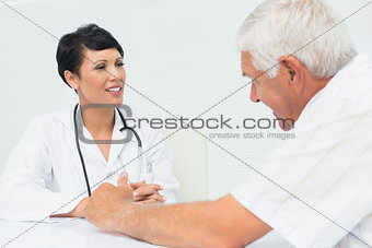 Female doctor attentively listening to senior patient