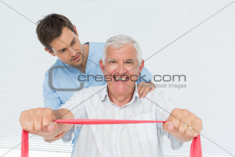 Male physiotherapist massaging senior mans back
