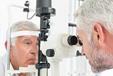 Optometrist doing sight testing for senior patient